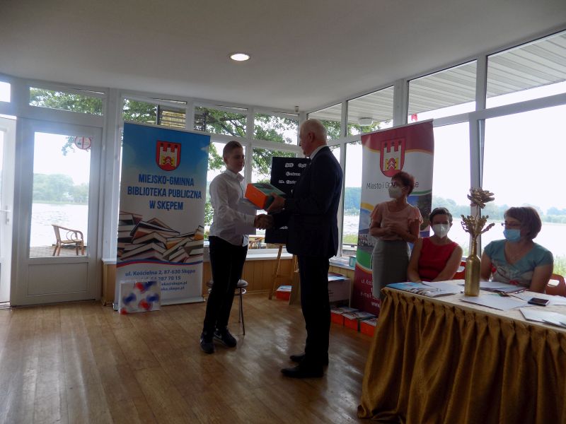 Zdjęcie przedstawia Burmistrza Miasta i Gminy Skępe wręczającego nagrodę uczestniczce konkursu